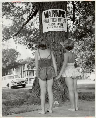 Kew Beach is also closed, as tree sign informs Sharon Benkendorf and Norma Burns, of Love Cres