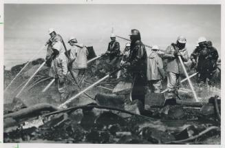 Hosing down: Workers with high-pressure hoses use warmed water to clean a Prince William Sound beach