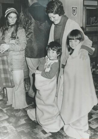 Priscilla Bainbridge hugs her children Craig, 4, and Lisa, 7