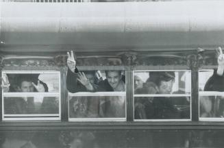 On way to new prisons after a four-day convict rebellion at Kingston penitentiary inmates wave and give victory sign as they are transferred by bus yesterday