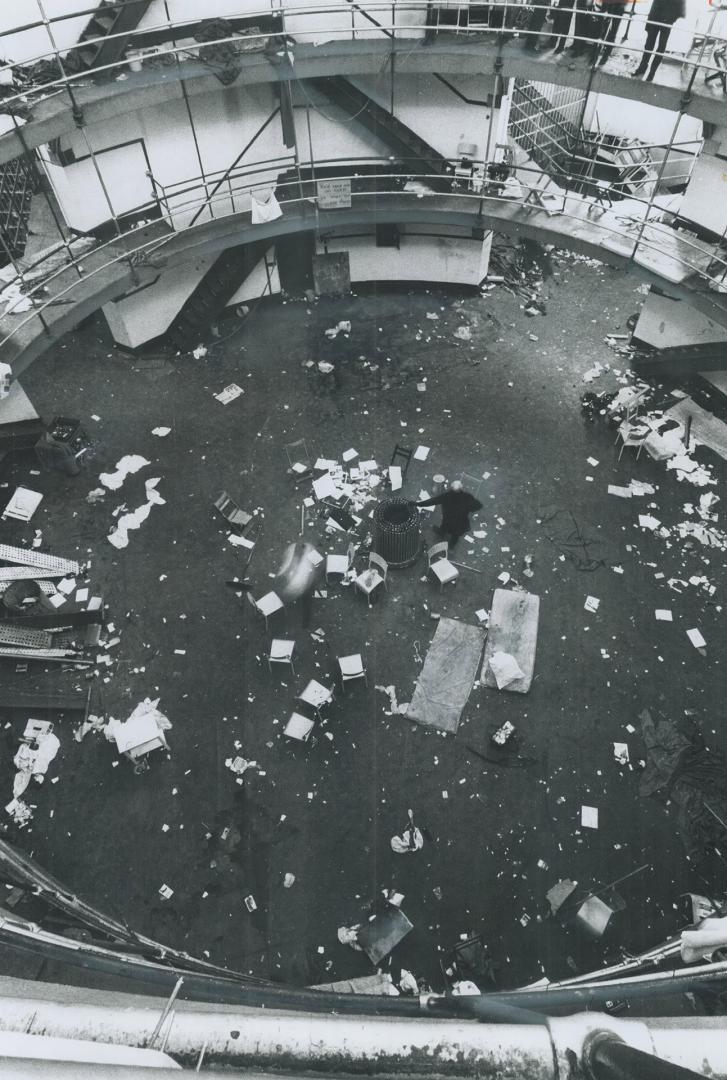 Litter-Strewn Dome of the central cellblock at Kingston Penitentiary is surveyed by regional director of penitentiaries John Moloney in the wake of th(...)