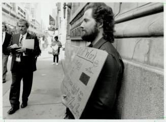 Sign of times: As the recession drags on and unemployment mounts, untold numbers of the unemployed, such as this man at a downtown corner, are depending on the charity of others to see them through