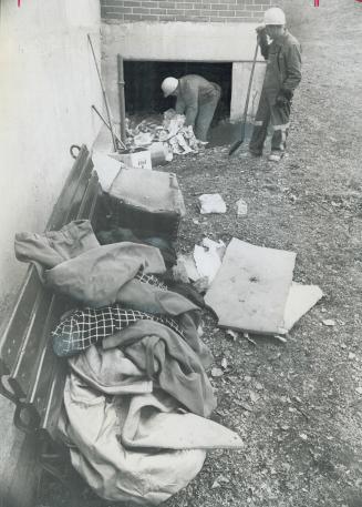 Doing the housecleaning for a home in a hole in the ground leading under the Rosedale subway, city workmen Peter Marchese and Frank Capapello remove d(...)