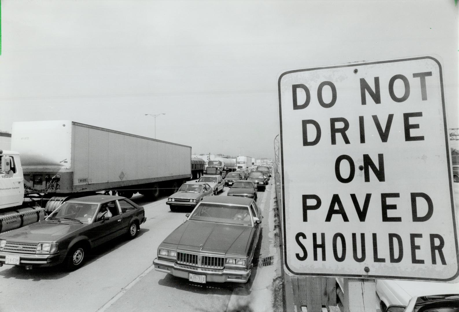 Signs of frustration: Metro motorists drive on the shoulders of the highways as protesting truck drivers slowed traffic yesterday, the second day in a row truckers used their rigs to tie up roads