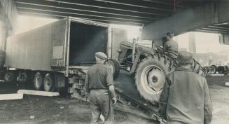 John Timermans of Parkhill loads first tractor, 25 used in yesterday's demonstration will be trucked to their owners' homes