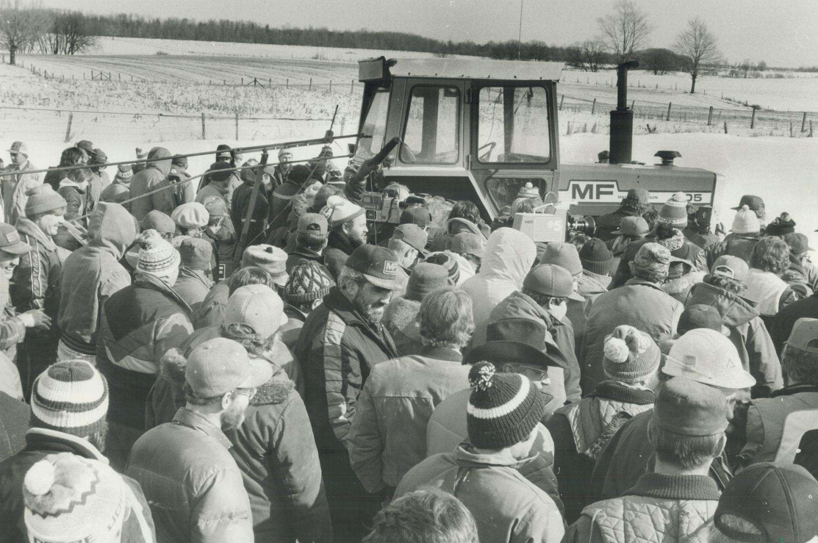 PM tightwalks. Low bidders: About 500 farmers took over a farm-liquidation auction near Palmerston. They conducted the auction themselves and bought about $100,000 worth of equipment for $19.81