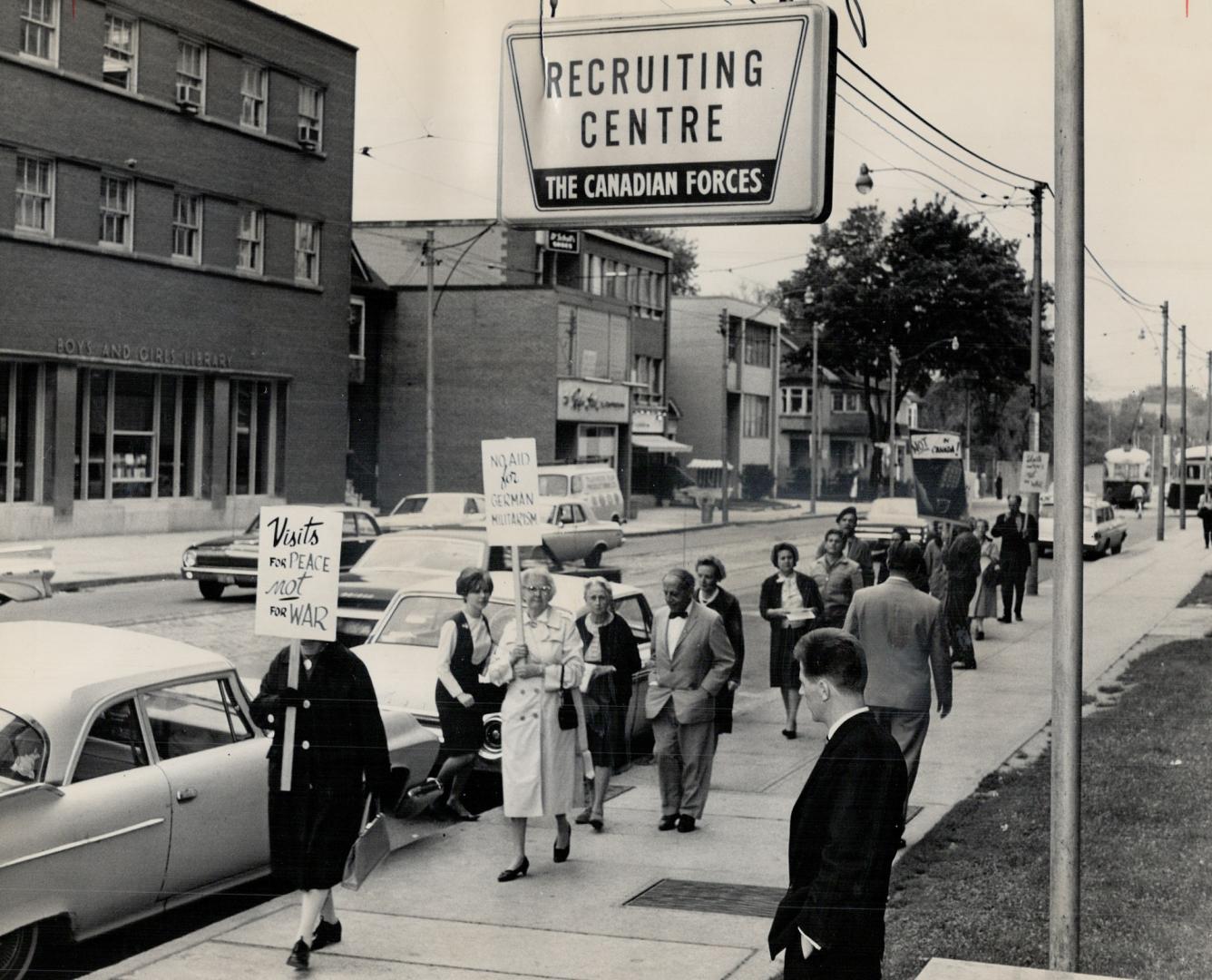 Keep German troops out, Some two dozen members of the Canadian Peace Congress paraded outside the Canadian Army recruiting office on St. Clair Ave. ju(...)