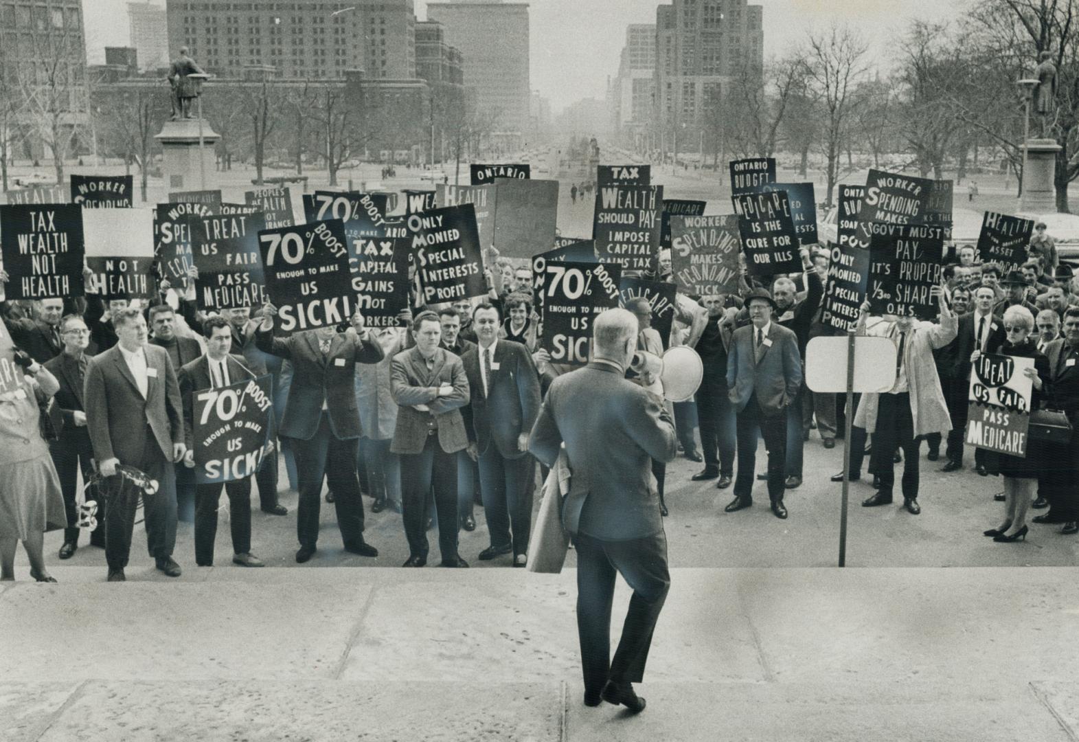 Unionists Picket Queen's Park, We want Robarts, 180 unionists chanted today as they paraded in front of the Legislature protesting tax increases and higher hospital insurance premiums