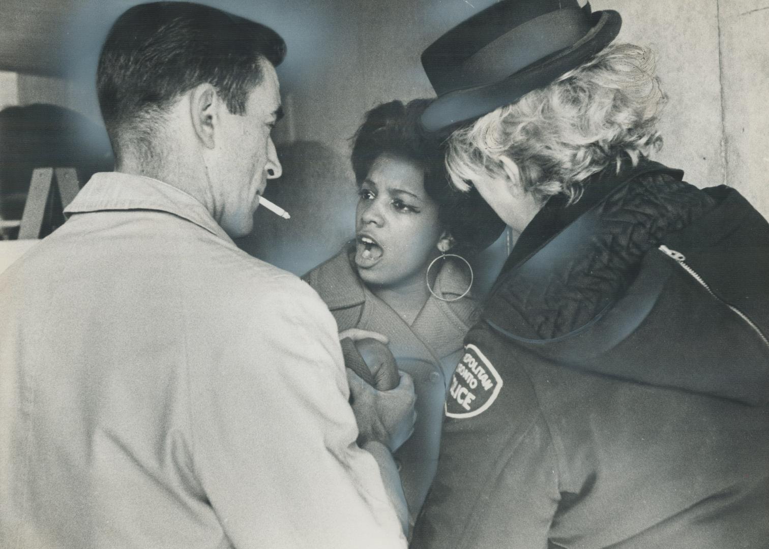 Plainclothes officer at City Hall tightly grips the arm of 17-year-old Linda Bradshaw, a Central Commerce student, one of thousands in Metro who walke(...)