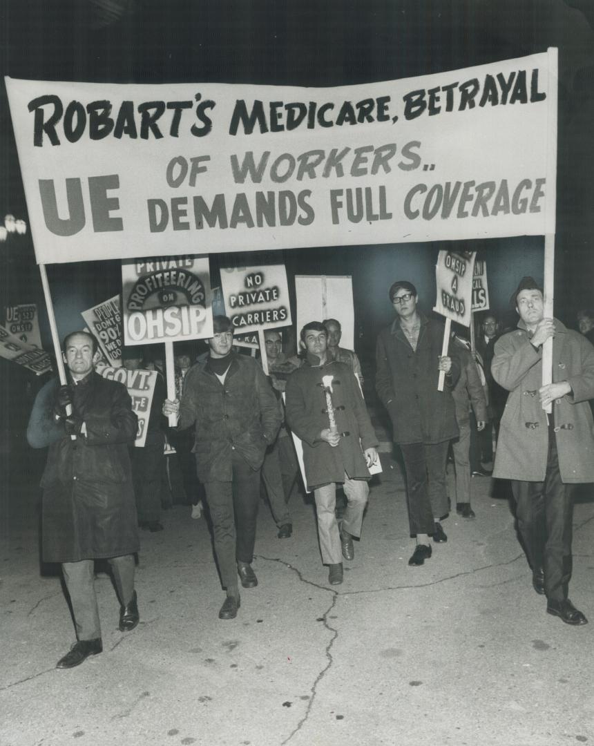 A premium protest: Members of the United Electrical and Radio Workers march at Queen's Park last night to protest premiums and double billing by the Ontario Hospital Services Insurance Plan