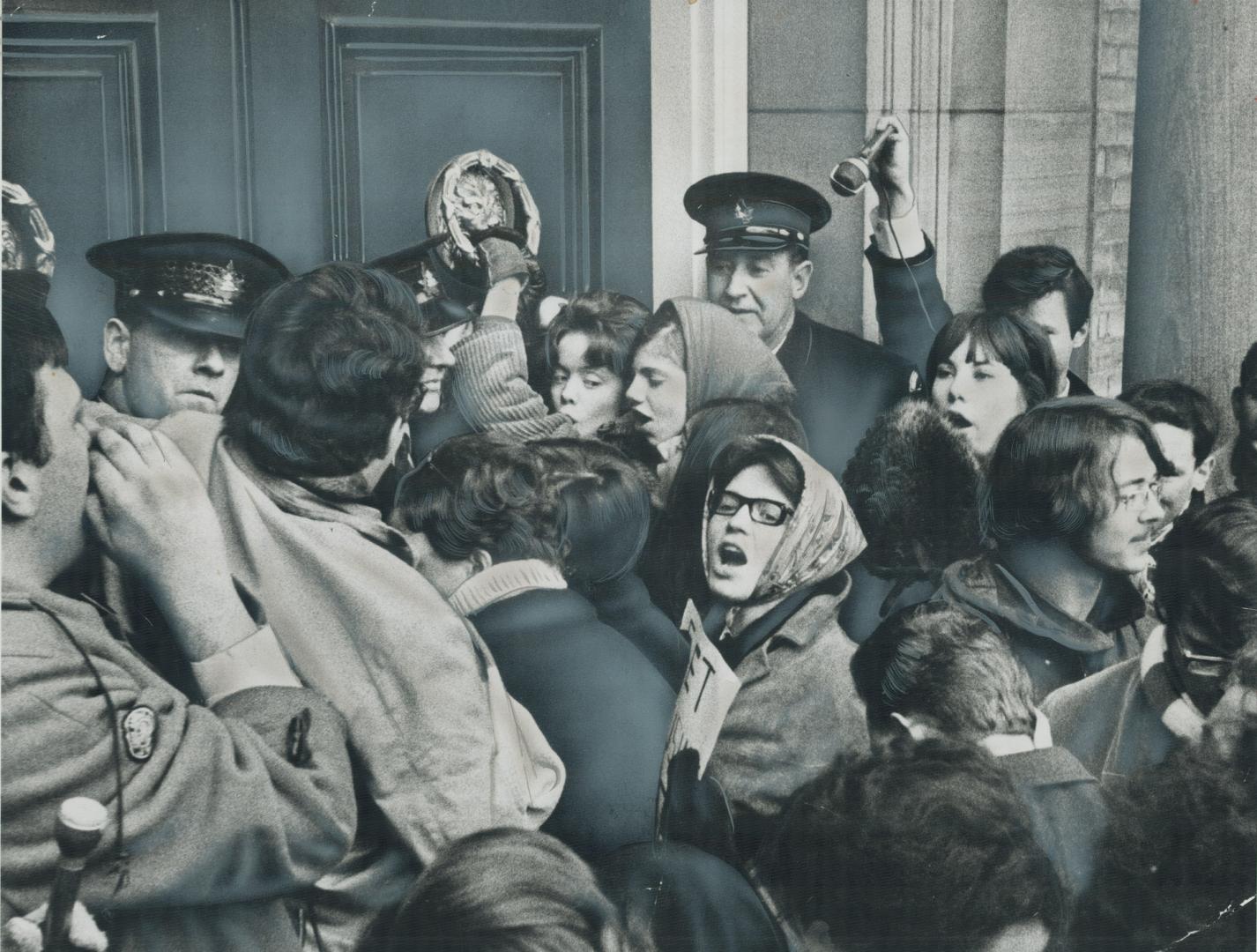 The Door slams on student protest, Their way blocked by campus policemen guarding the locked doors of University of Toronto's central administration, (...)