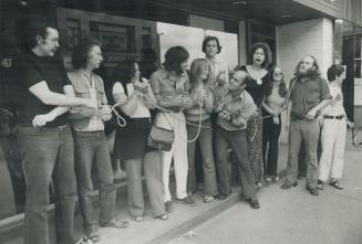 Metro artists tie themselves together with rope outside the Isaac Gallery to protest against the appointment of an American, Richard J. Wattenmaker, o(...)