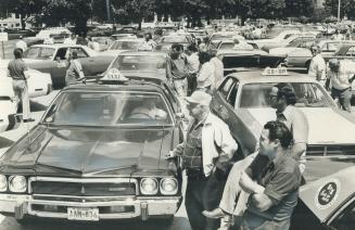 Hundreds of taxis surround Queen's Park as their drivers demand more protection and protest the release on $2,000 bail of one of three men charged wit(...)