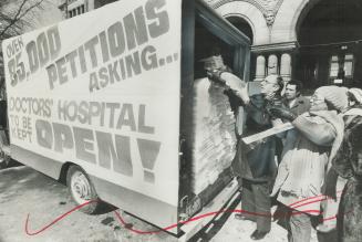 Queen's pair demonstrators start to unload petitions signed by 86,000 persons protesting the government's order closing Doctors Hospital in Toronto. [Incomplete]