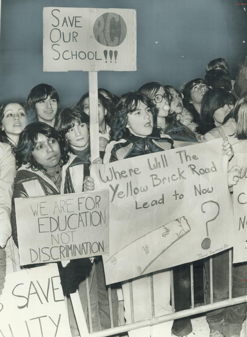 Placard-carrying students from River-dale Collegiate march on the Legislature last night to protest the layoff of 12 of their teachers. Student Counci(...)