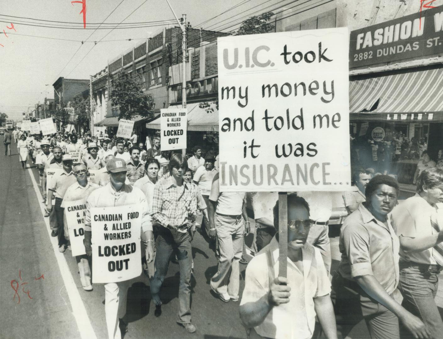 Protesting Canada Packers workers march against the stalling of a decision on jobless benefits for them