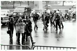 About 50 motorcycles riders, members of the Bikers' Rights Association of Canada, turned out in pouring rain at Queen's Park yesterday to protest the (...)