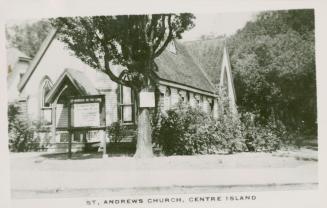 Picture of white clapboard church surrounded by trees. 