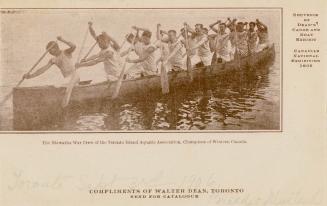 Sepia coloured picture of more than a dozen rowers paddling in a large canoe. 