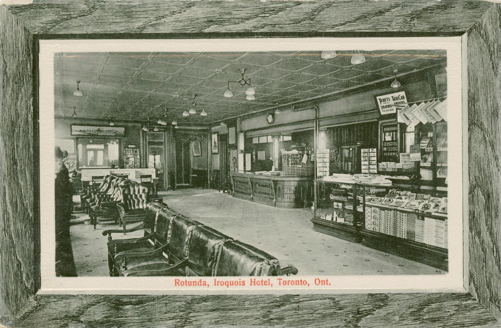 Black and white picture of a lobby in a hotel. rain border. Picture has a woodgrain border