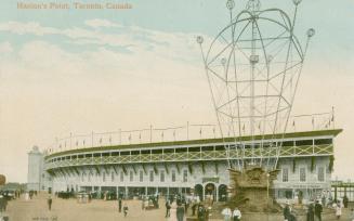 Picture shows people standing on the outside of a baseball stadium.