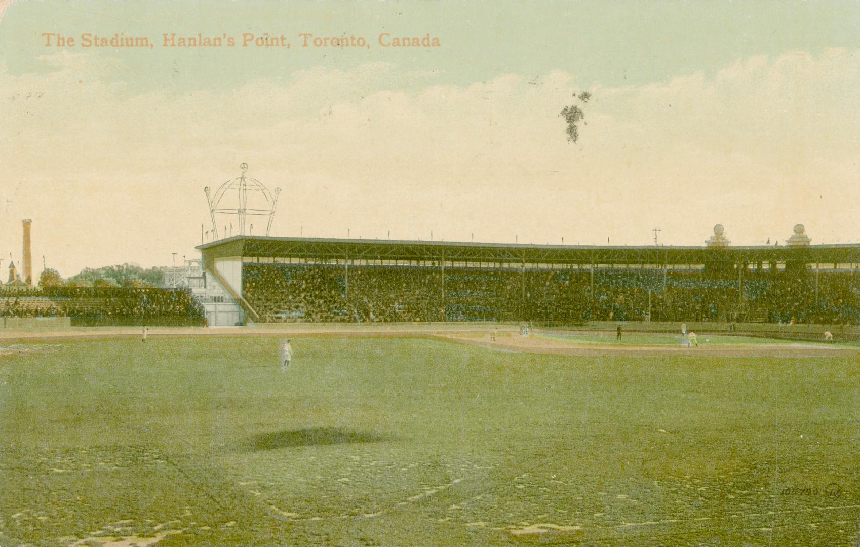 Shows a stadium from the perspective of a baseball field.