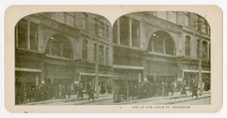 Pictures show a crowd of shoppers outside the front door of a large building.