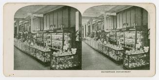 Pictures show elegant cases of silverware in a large store.