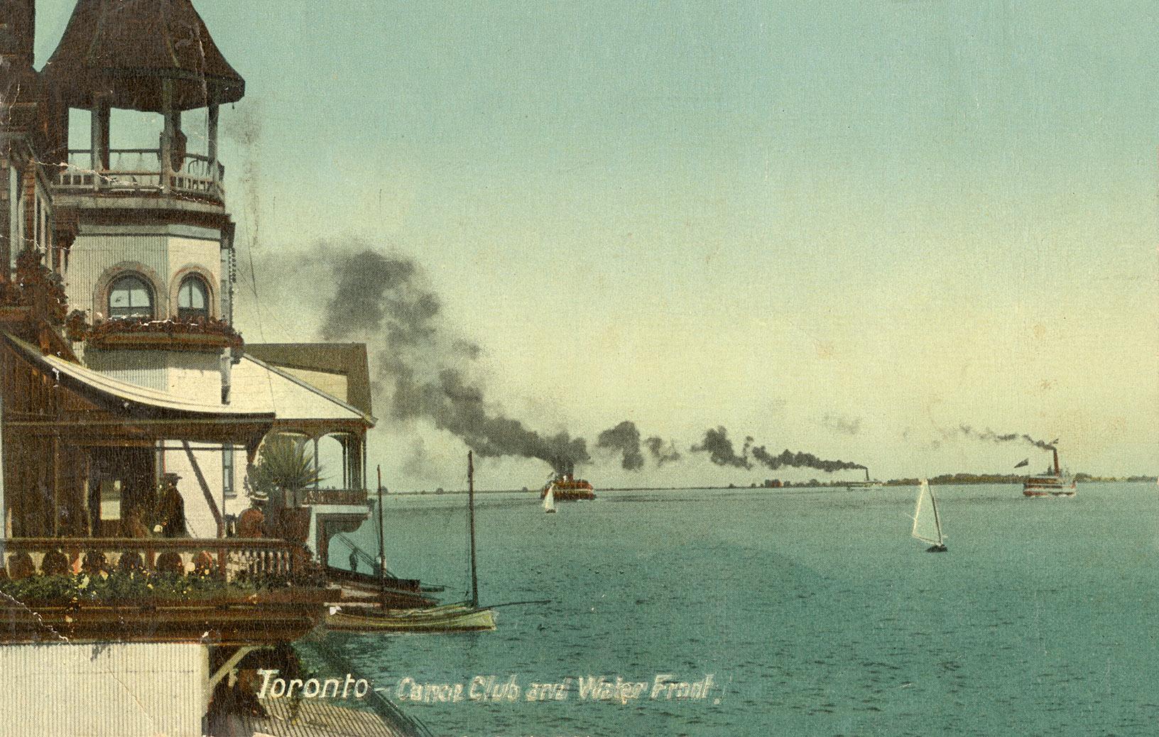 Picture show sail boats on open water with the front of a white, Victorian building at the left…