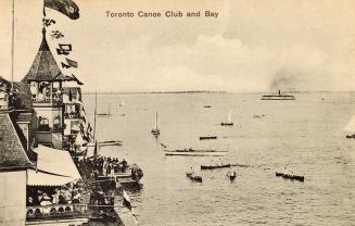 Black and white picture shows a large Victoria building overlooking a body of water with ships …