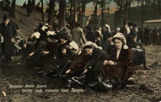 A group of people lacing up their skates. 