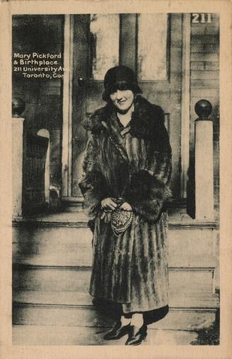 Mary Pickford standing in front of the house where she was born.
