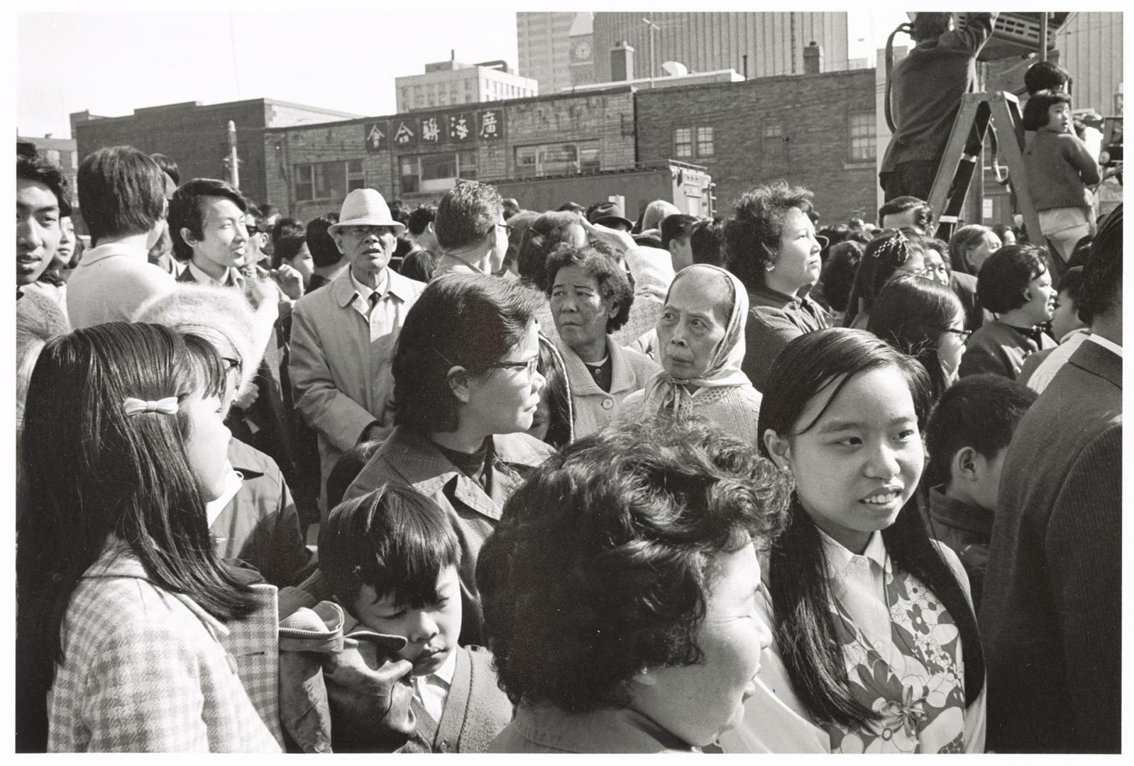 A photograph of a group of spectators at an outdoor event in downtown Toronto.