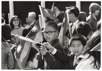 A photograph of a group of spectators at an outdoor event in downtown Toronto.