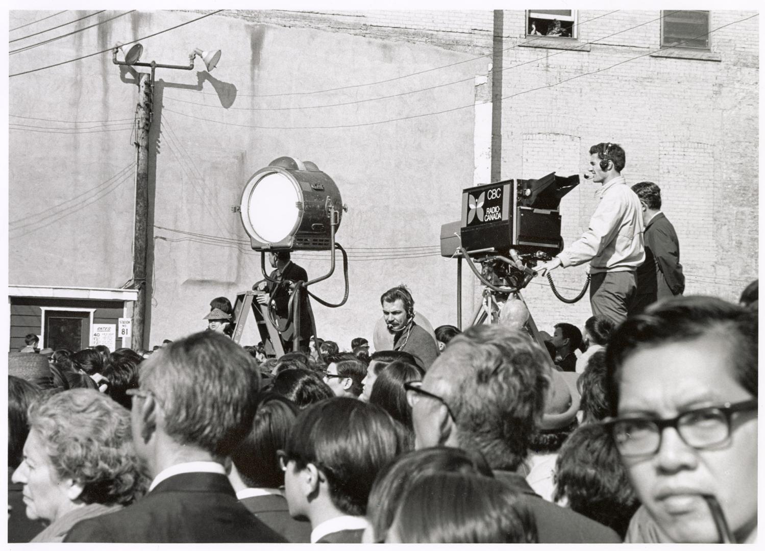 A photograph of a group of spectators at an outdoor event in downtown Toronto