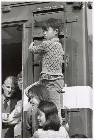 A photograph of a group of spectators at an outdoor event in downtown Toronto.