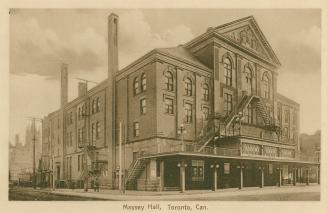 Sepia toned picture of a large theatre with prominent fire escapes.