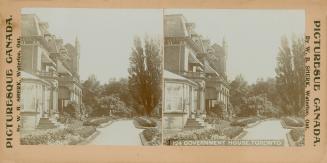 Pictures show and alternate side of a large, chateau style mansion with a road banked with flow…