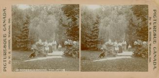 Pictures show a group of people standing at a gate to a park