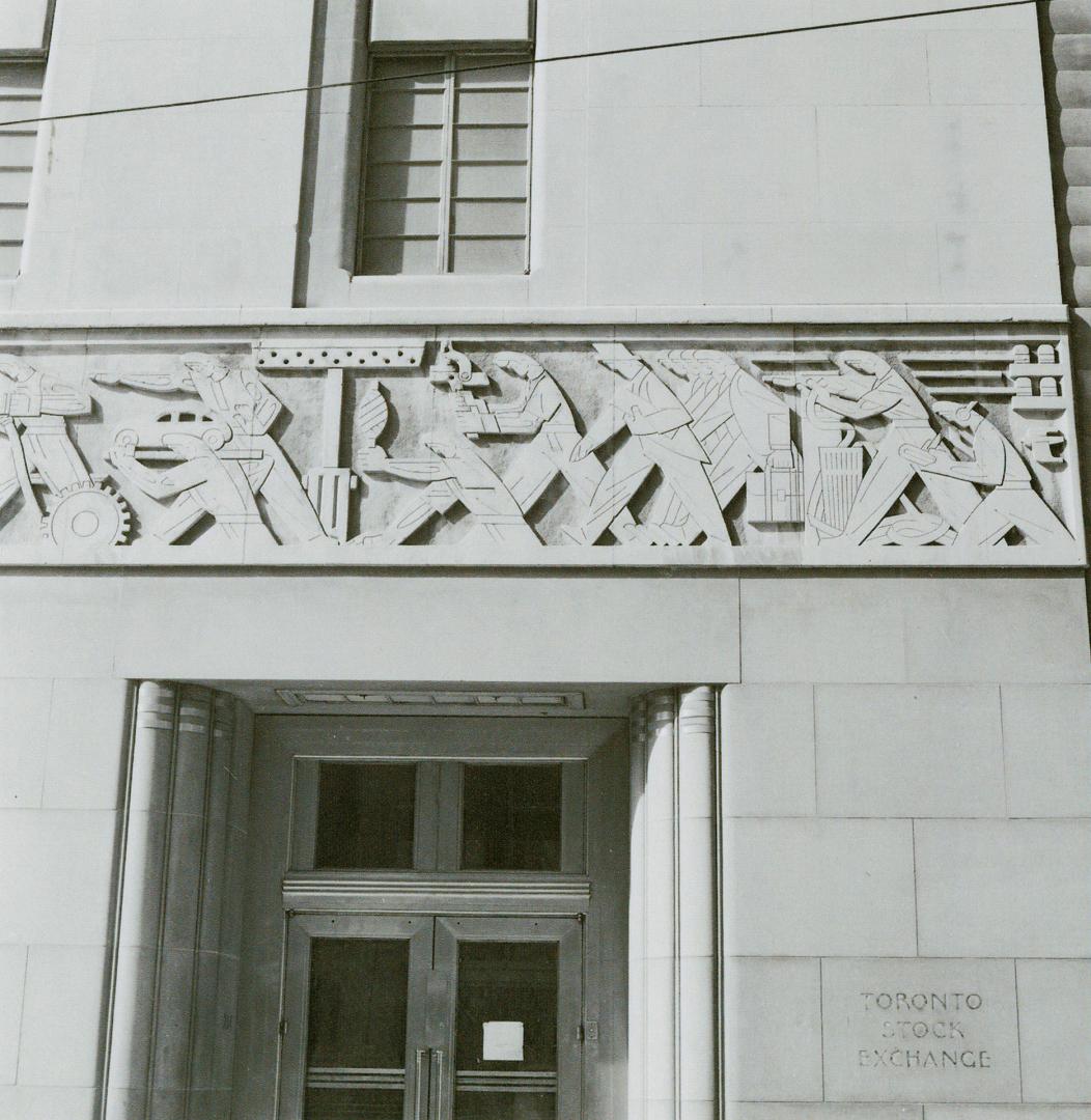 A photograph of a frieze above a doorway, depicting workers in various industries and professio…