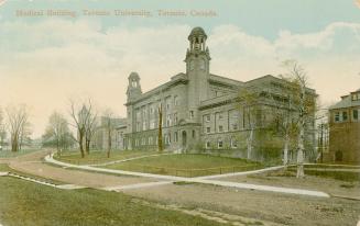 Colorized photograph of a three storied building with two towers.