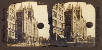 Pictures show a huge Romanesque Revival style building on a downtown street.