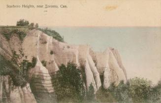 Colorized photograph of white cliffs overlooking a lake.