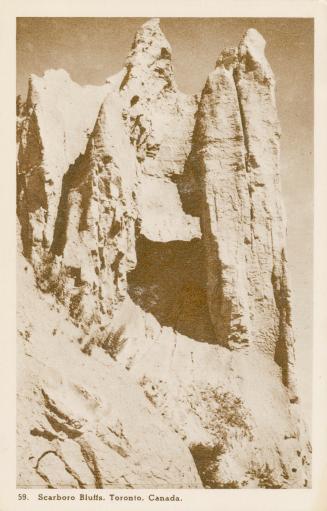 Black and white picture of white cliffs casting a shadow.