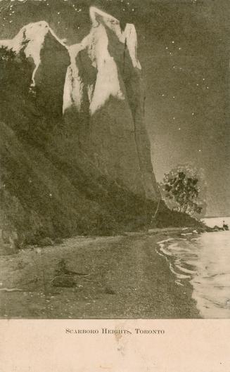 Black and white photograph of two white cliffs taken from the beach.