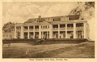 Sepia toned picture of a three story Victorian club house with verandahs on the front.