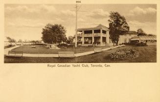 Sepia toned photograph of a large Victorian structure with verandah on manicured grounds.