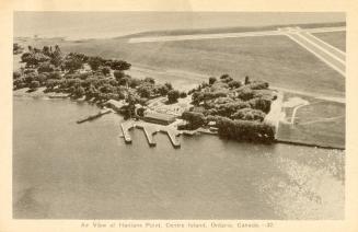 Black and white aerial shot of an island with an airport strip.