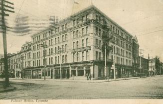 Black and white picture of a five story hotel building taken from a corner.