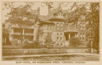 Black and white photograph of a Queen Anne style mansion with front porch and verandahs.